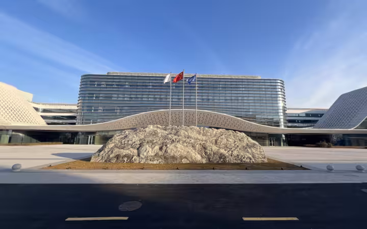 CSCN headquarters in Xiong'an behind a rocky plaza and three flagpoles