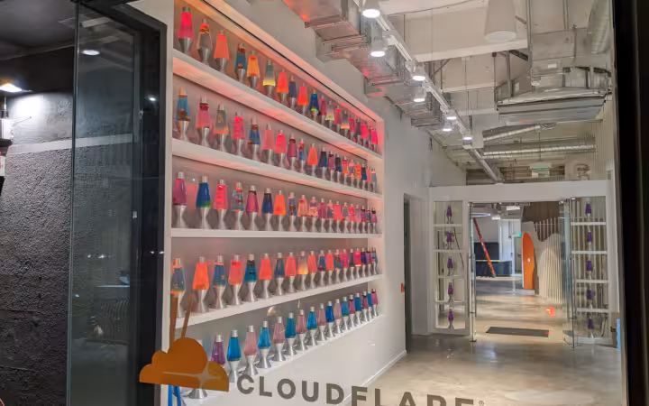 Colorful lava lamps line a wall inside Cloudflare's San Francisco office.