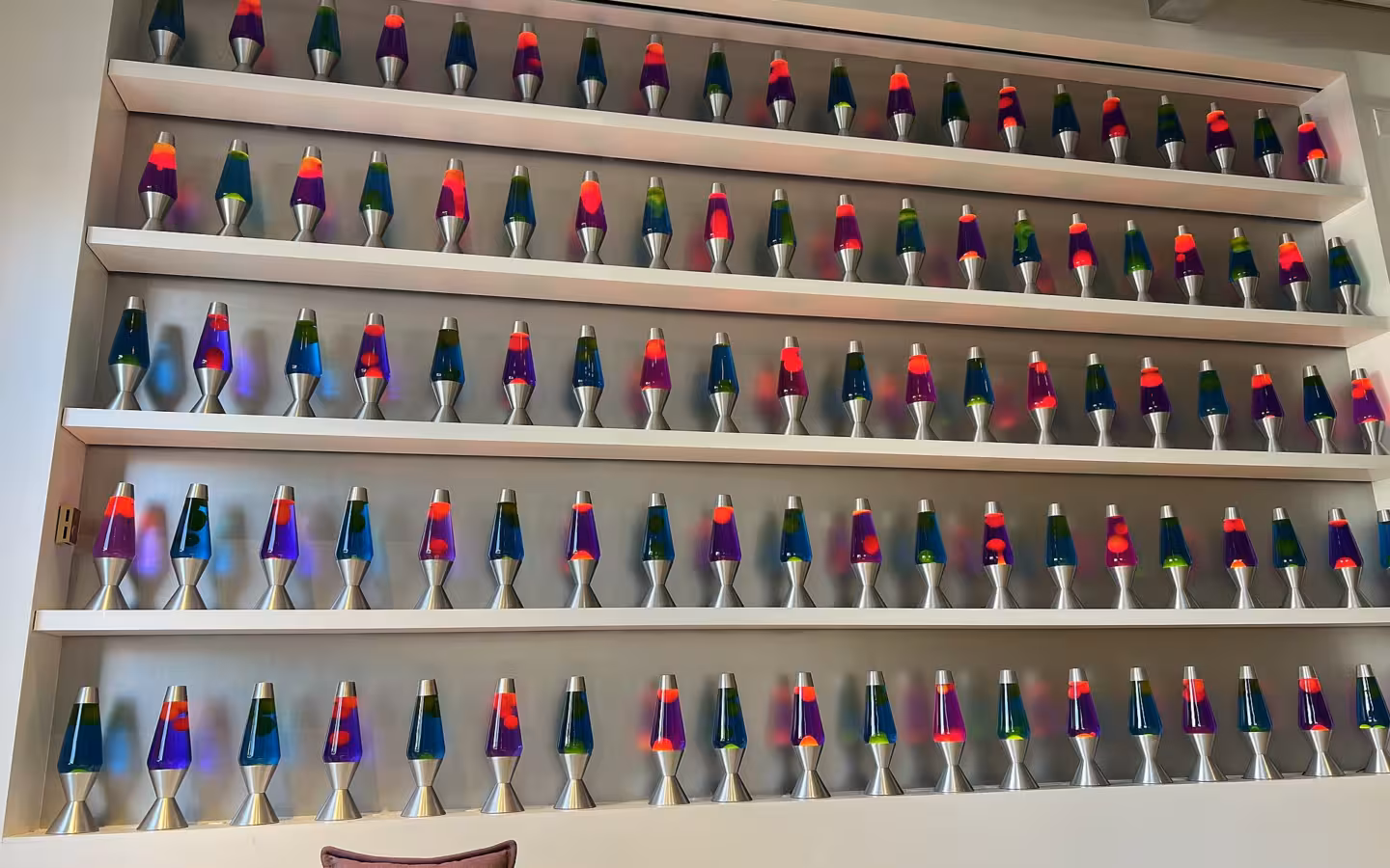 Rows of colourful lava lamps line shelves at Cloudflare.