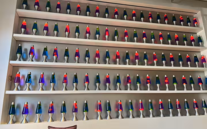Rows of colourful lava lamps line shelves at Cloudflare.