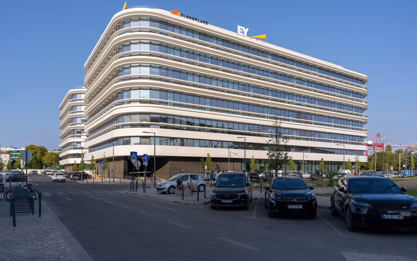 Cloudflare and EY office complex in Lisbon with parked cars outside