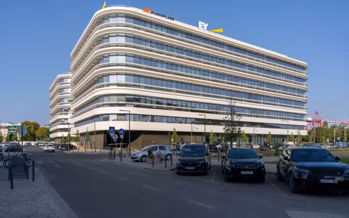 Cloudflare and EY office complex in Lisbon with parked cars outside