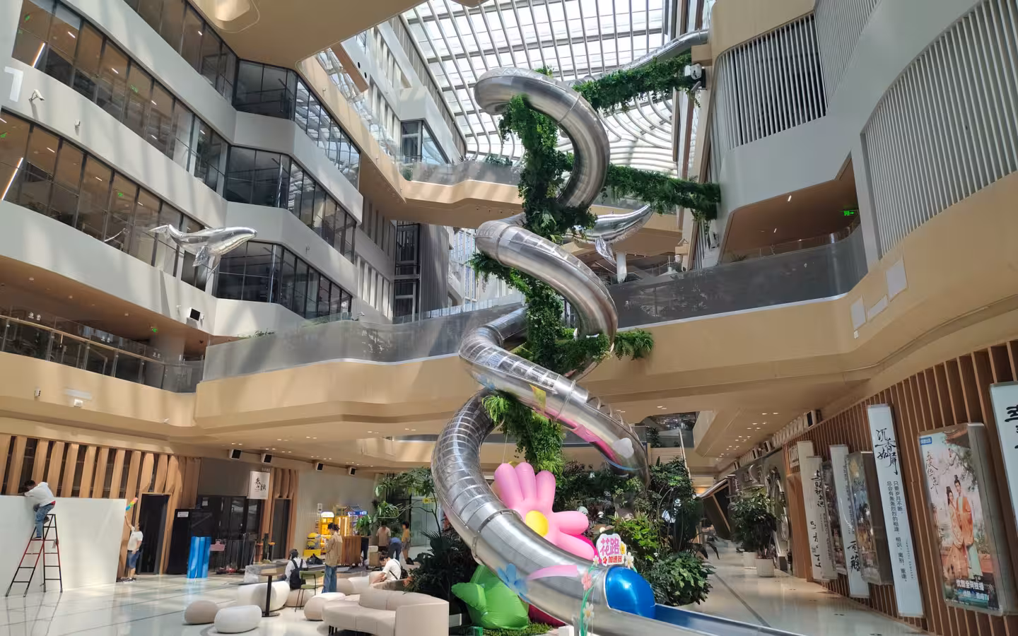 Alibaba Chaoyang Technology Park guest center atrium with large spiral slides