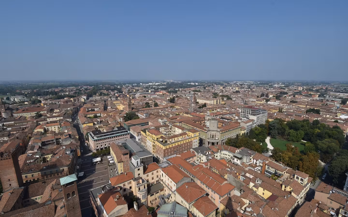 An elevated view across the rooftops and streets of Cremona, Italy.