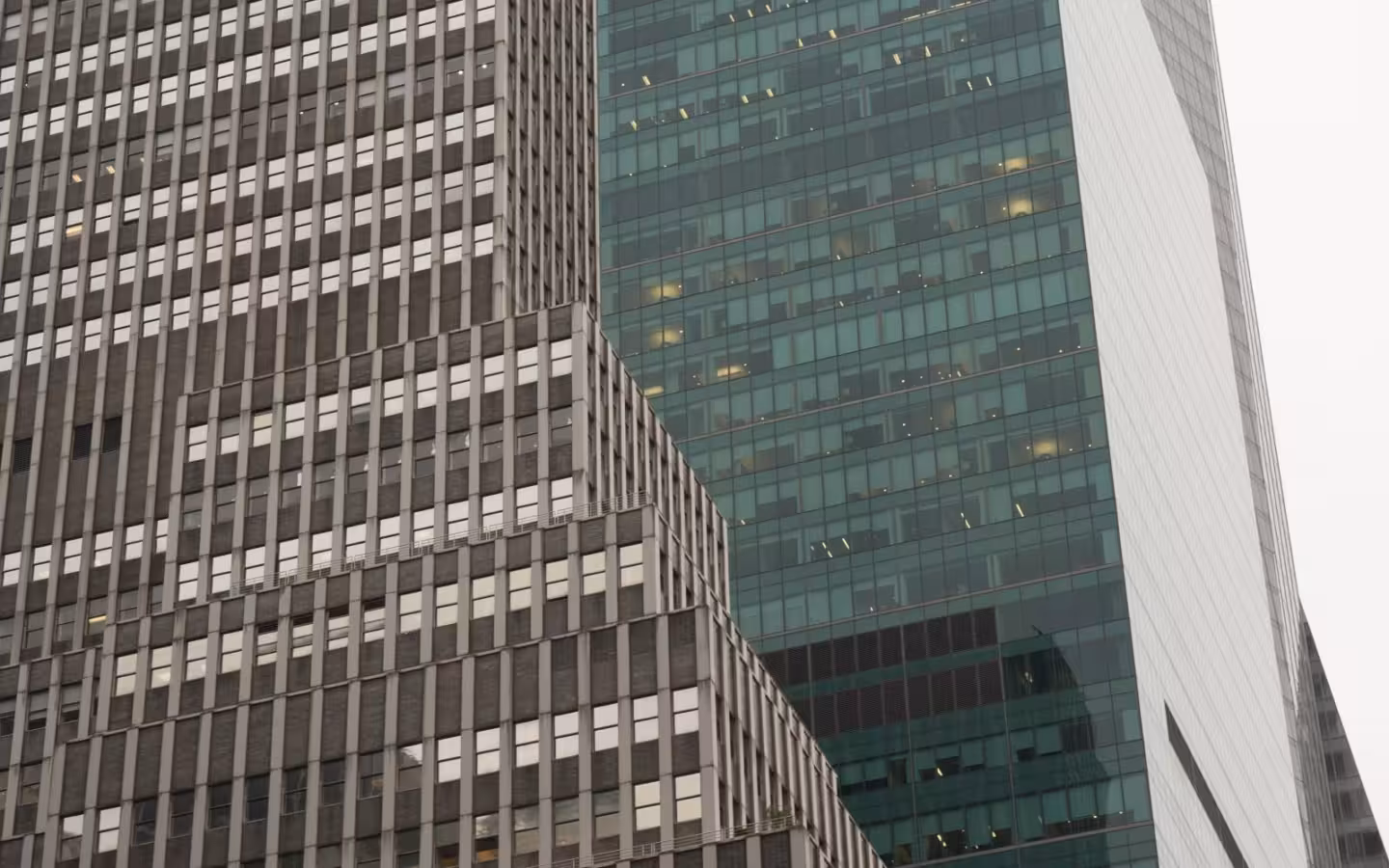 Low-angle view of 1065 and 1095 Avenue of the Americas.