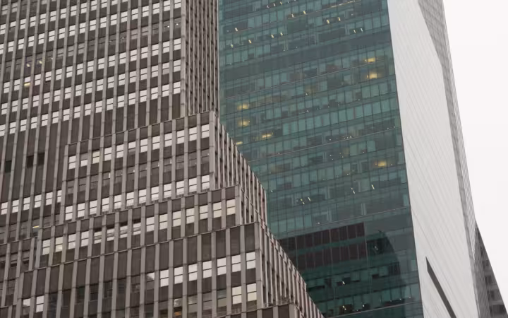 Low-angle view of 1065 and 1095 Avenue of the Americas.
