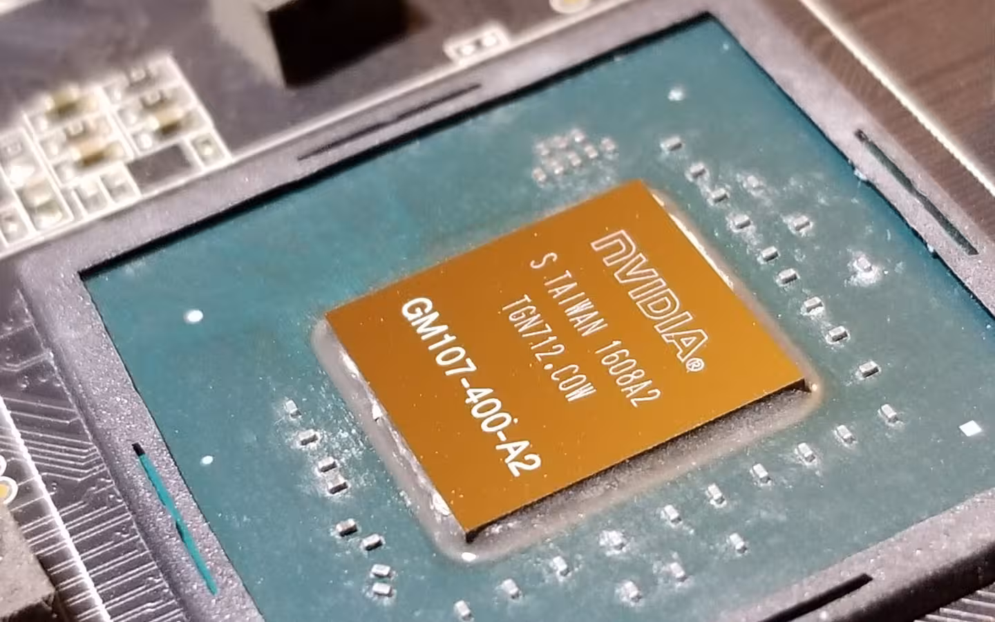 A close-up of an NVIDIA GM107-400-A2 GPU mounted on a circuit board.