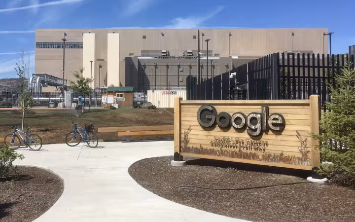 Google sign outside a fenced data center building in The Dalles, Oregon