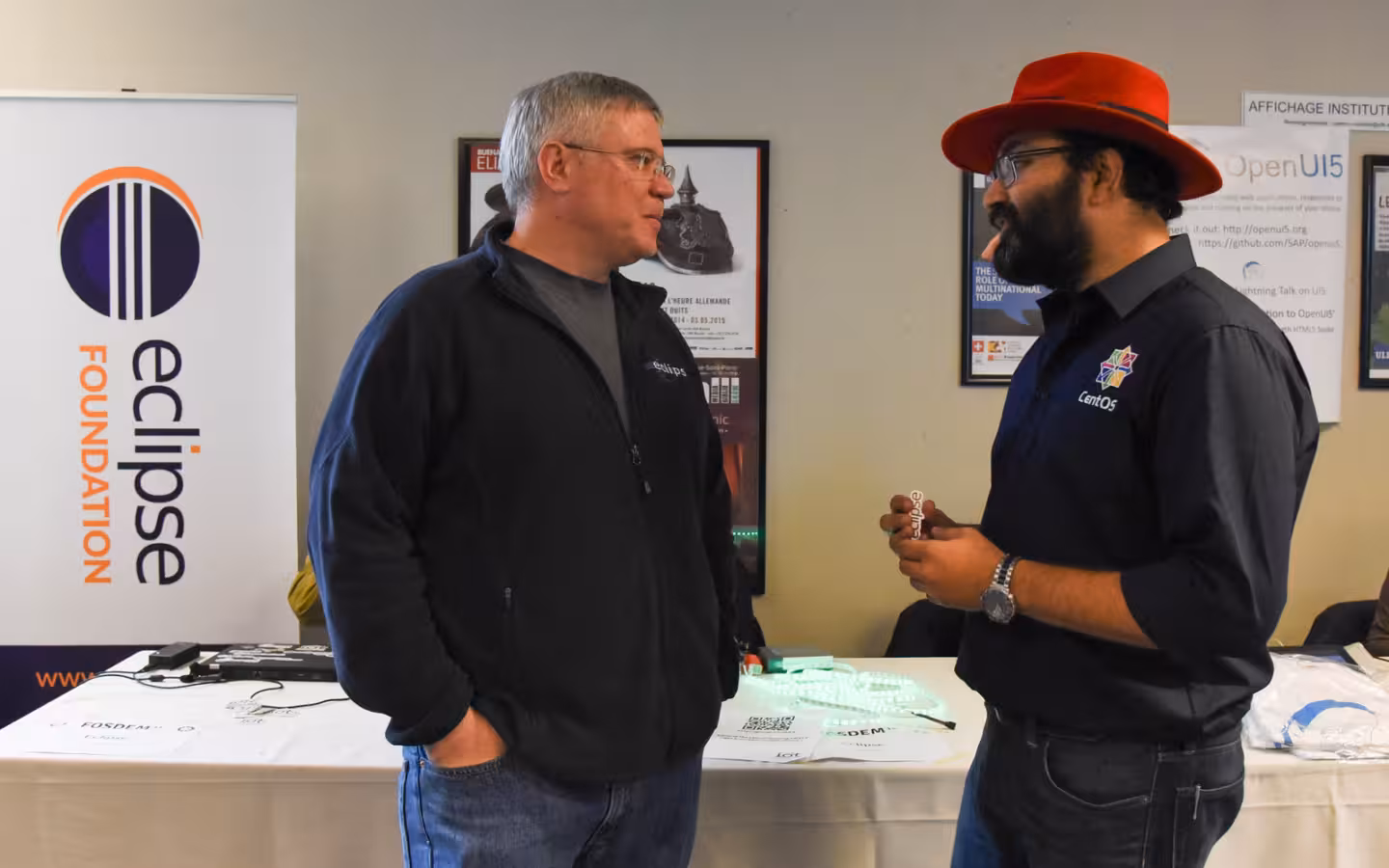 Mike Milinkovich and KB Singh talking beside an Eclipse Foundation banner.