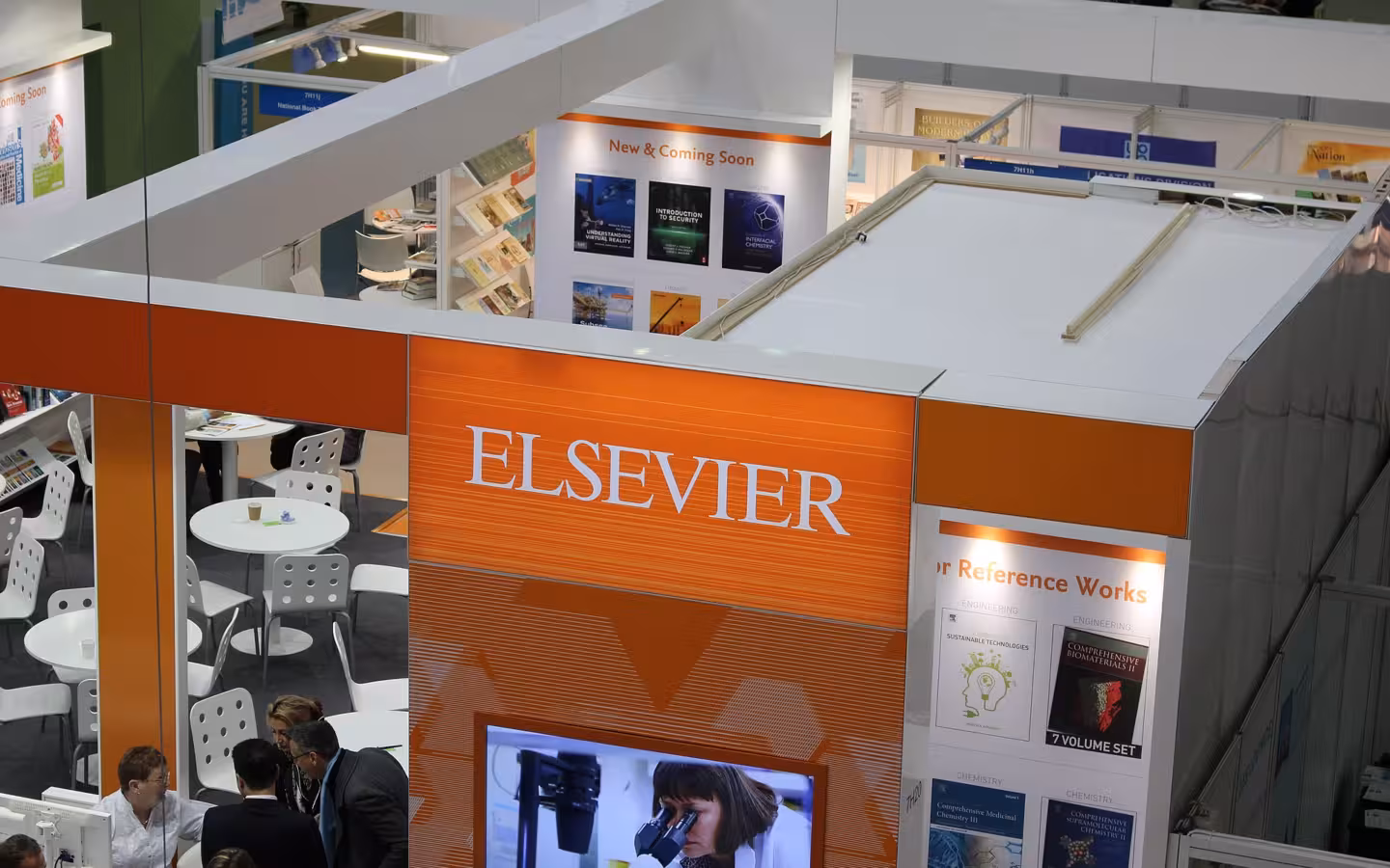 Elsevier’s orange exhibition booth and visitors at the 2018 London Book Fair