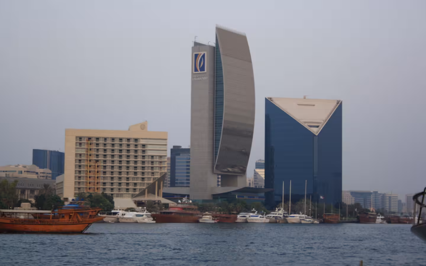 An Emirates NBD-branded tower overlooks boats on Dubai Creek.