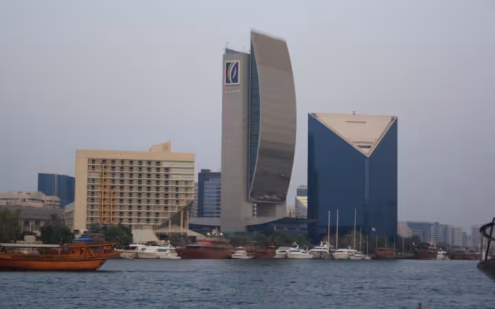 An Emirates NBD-branded tower overlooks boats on Dubai Creek.
