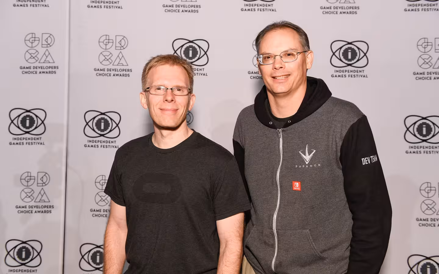 John Carmack and Tim Sweeney posing together before a games awards backdrop
