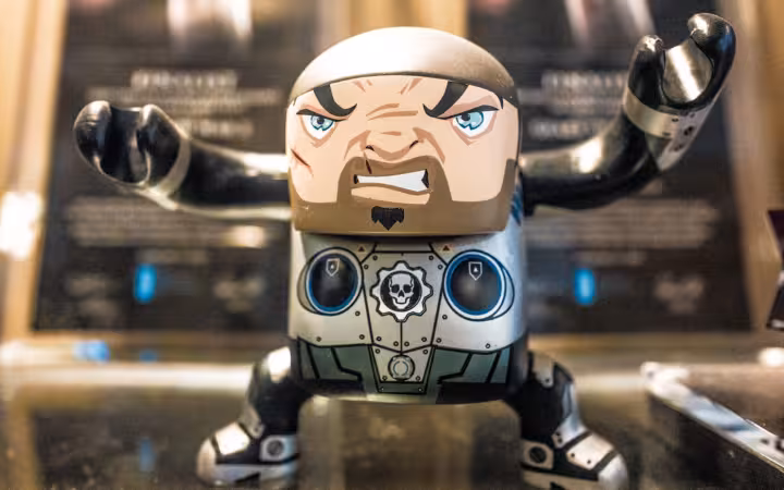 A Marcus toy figure poses with raised arms at Epic Games HQ.
