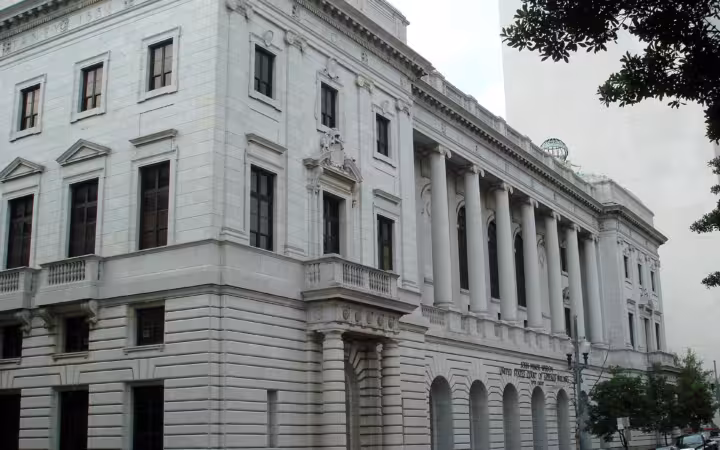 The John Minor Wisdom U.S. Courthouse beside a New Orleans street.
