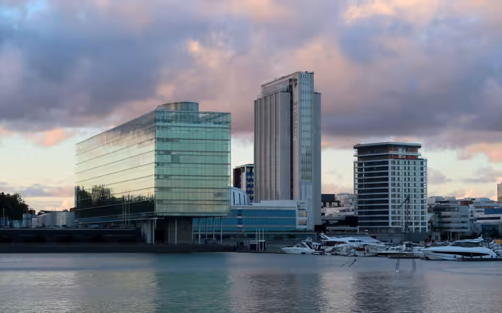 Waterfront buildings in Keilaniemi, Espoo, with Finago Tower and moored boats