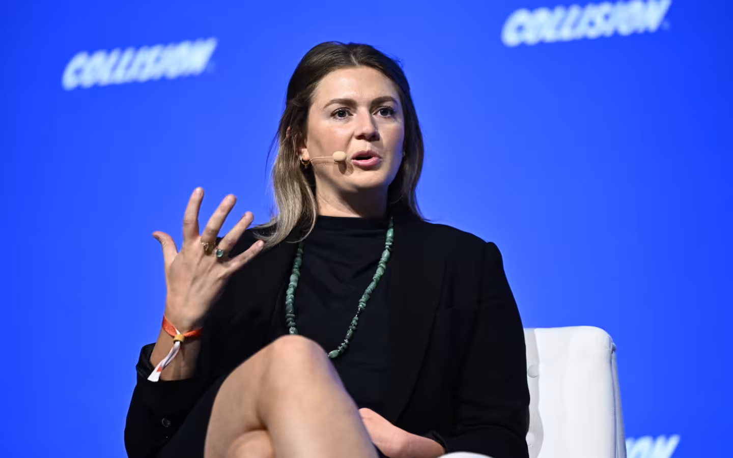 Erin Price-Wright speaking with a headset microphone on the Collision 2023 stage