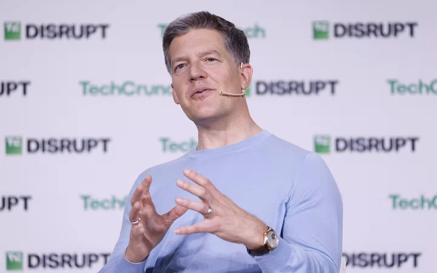 Roelof Botha speaking onstage before a TechCrunch Disrupt backdrop.