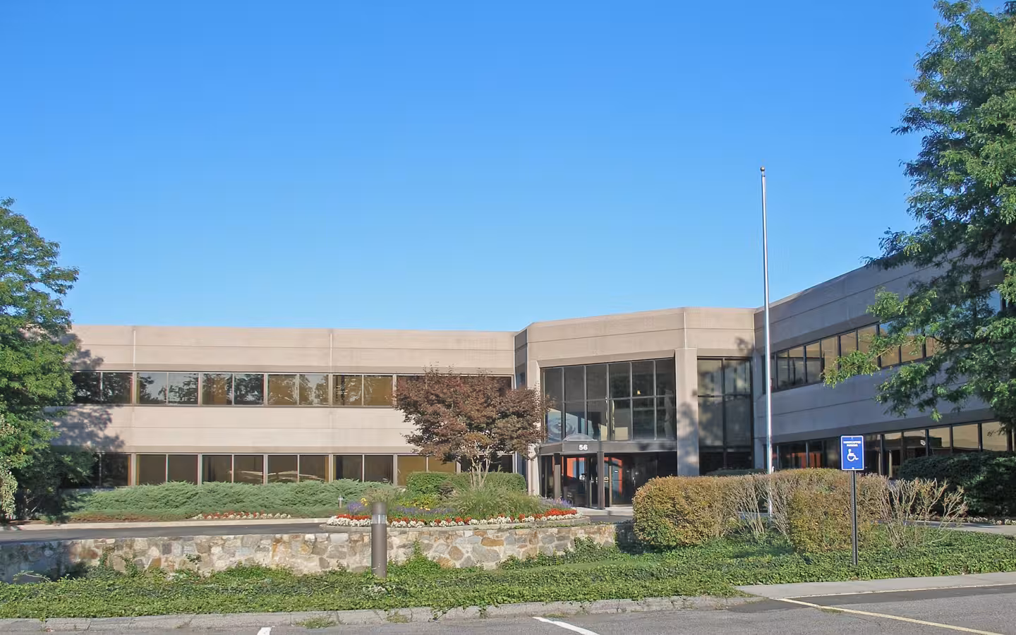 Gartner headquarters in Stamford, with landscaped grounds and a clear sky