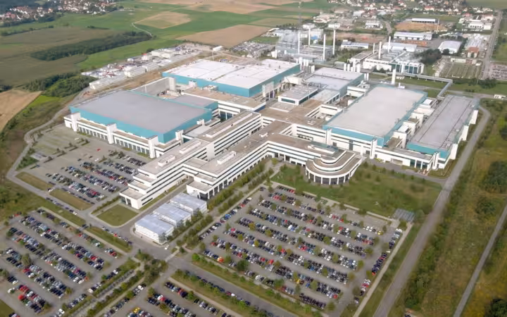Aerial view of GlobalFoundries Fab 1 in Dresden, with surrounding car parks