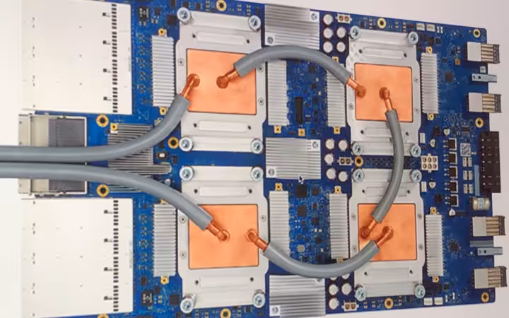 A Tensor Processing Unit 3.0 board with copper cooling plates and tubing