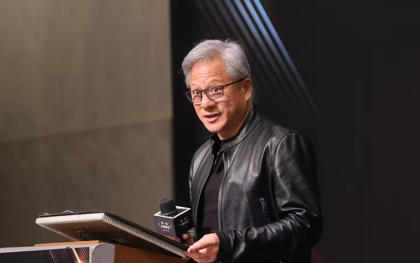 Jensen Huang speaks at a lectern during the K.T. Li Awards ceremony.