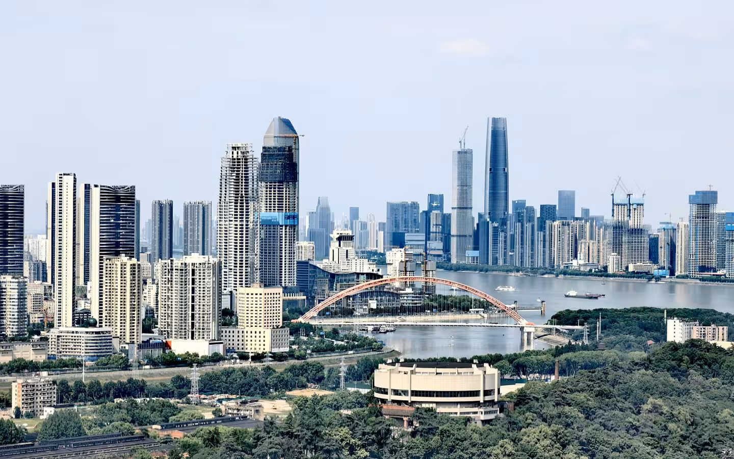 Wuhan skyline, river and arched bridge seen from a rooftop