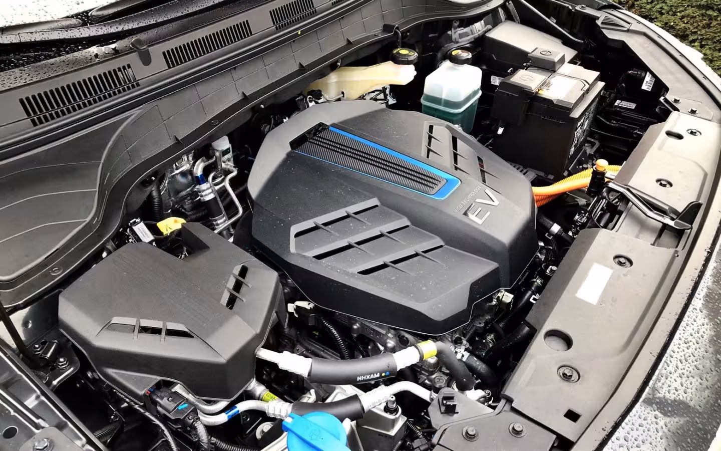 The under-hood components of a Hyundai Kona Electric fill the frame.