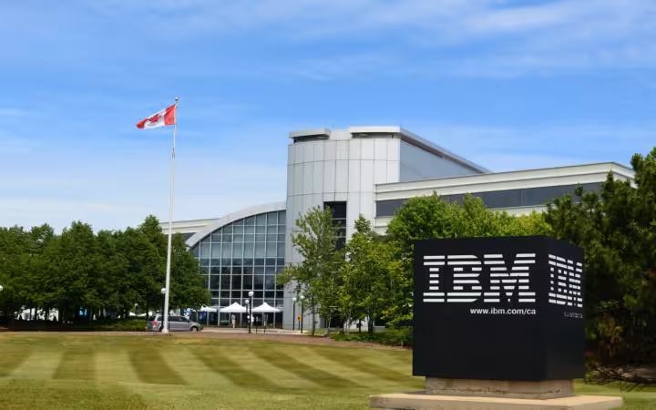 IBM Canada office building behind a large IBM sign and Canadian flag