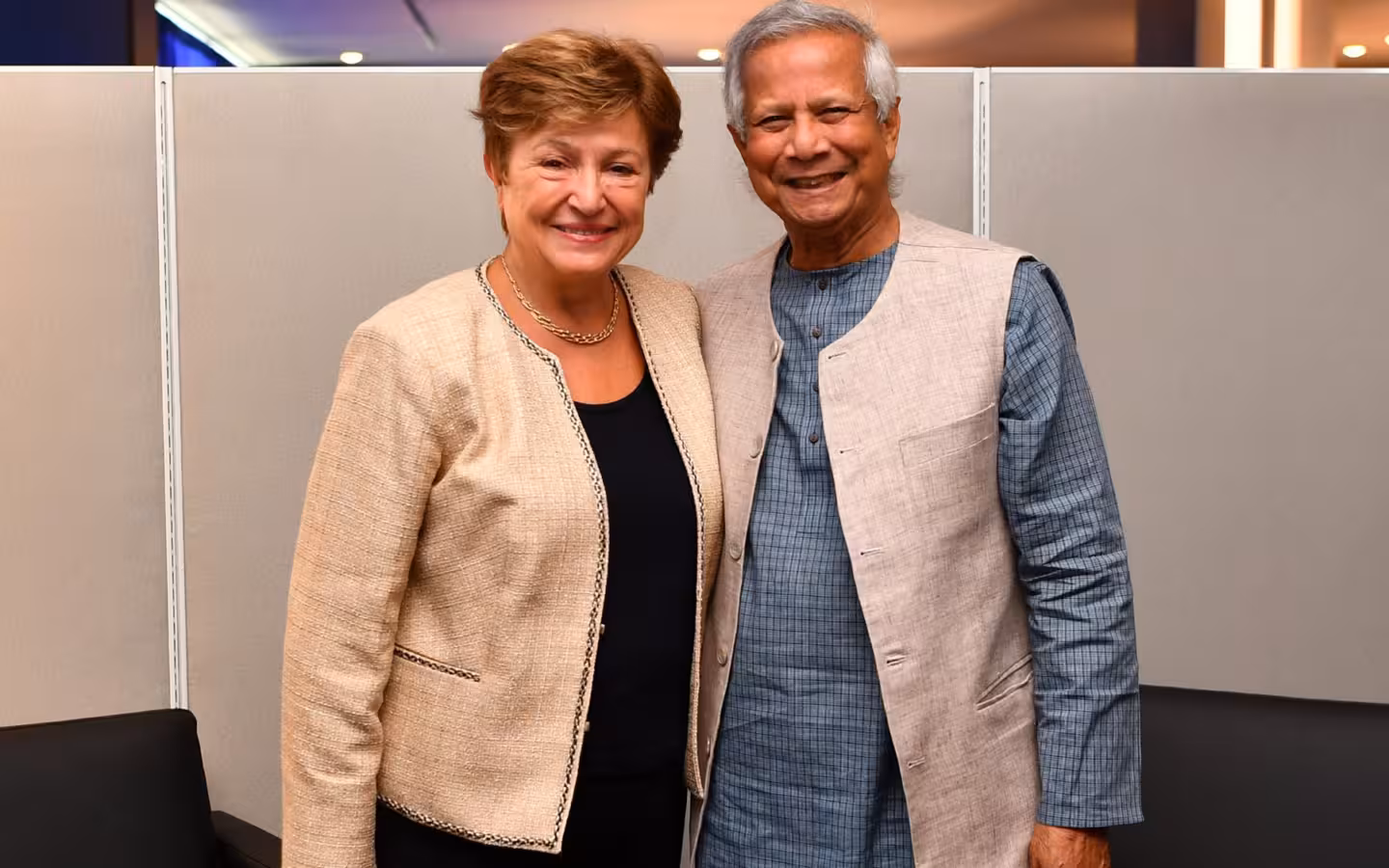 Kristalina Georgieva and Muhammad Yunus pose together before office partitions.