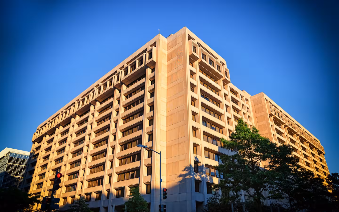 The International Monetary Fund building in Washington, D.C., beneath a clear blue sky