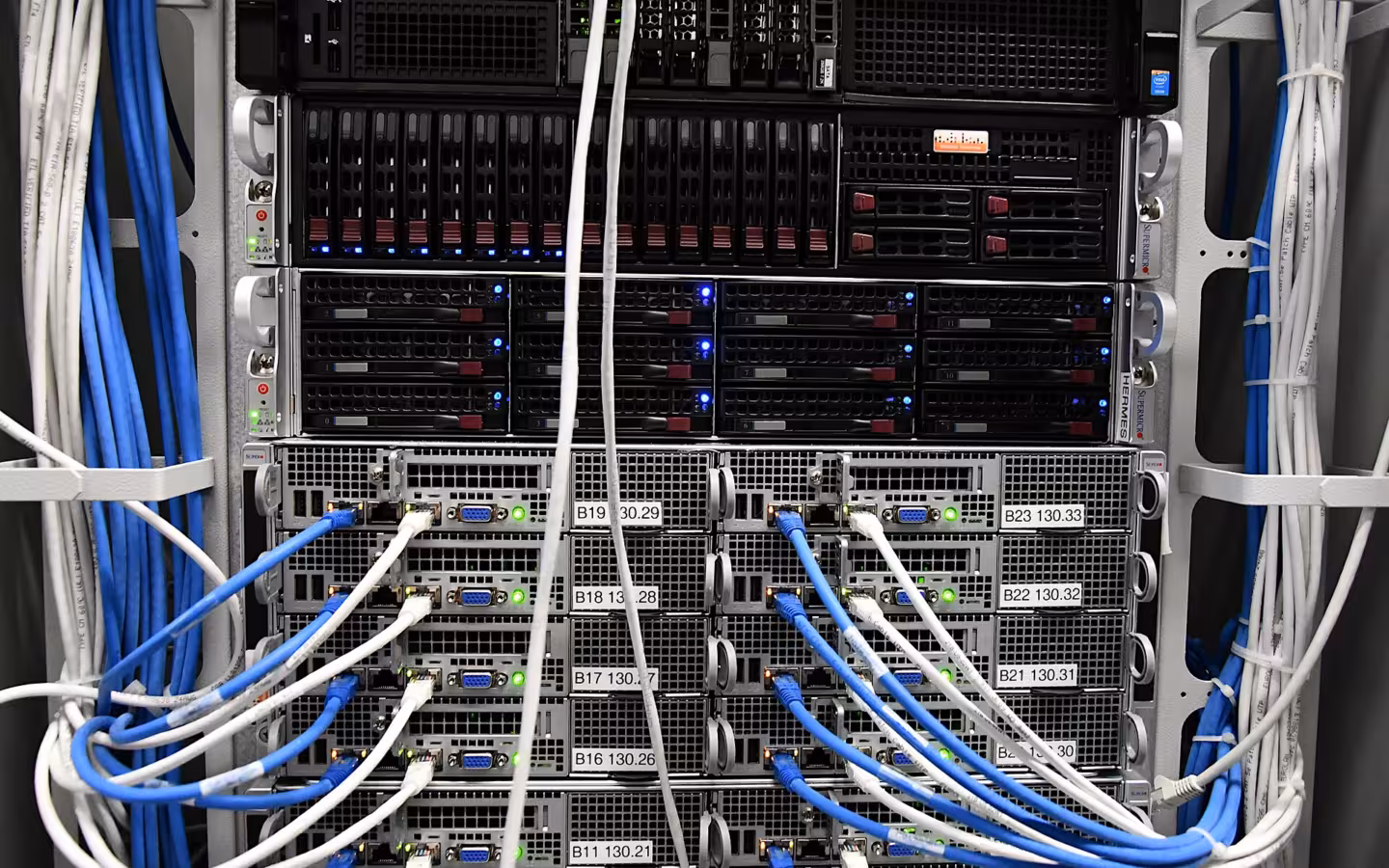 Chemicum servers in a rack with bundles of blue and white cables