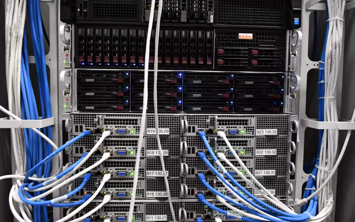 Chemicum servers in a rack with bundles of blue and white cables