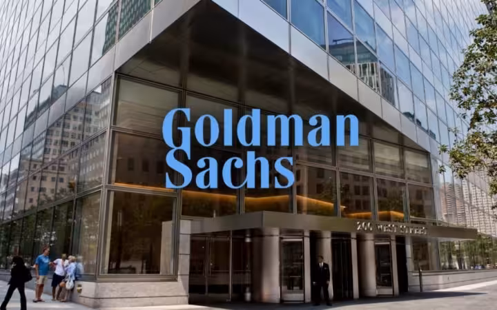 Goldman Sachs signage above the entrance to a glass-fronted building