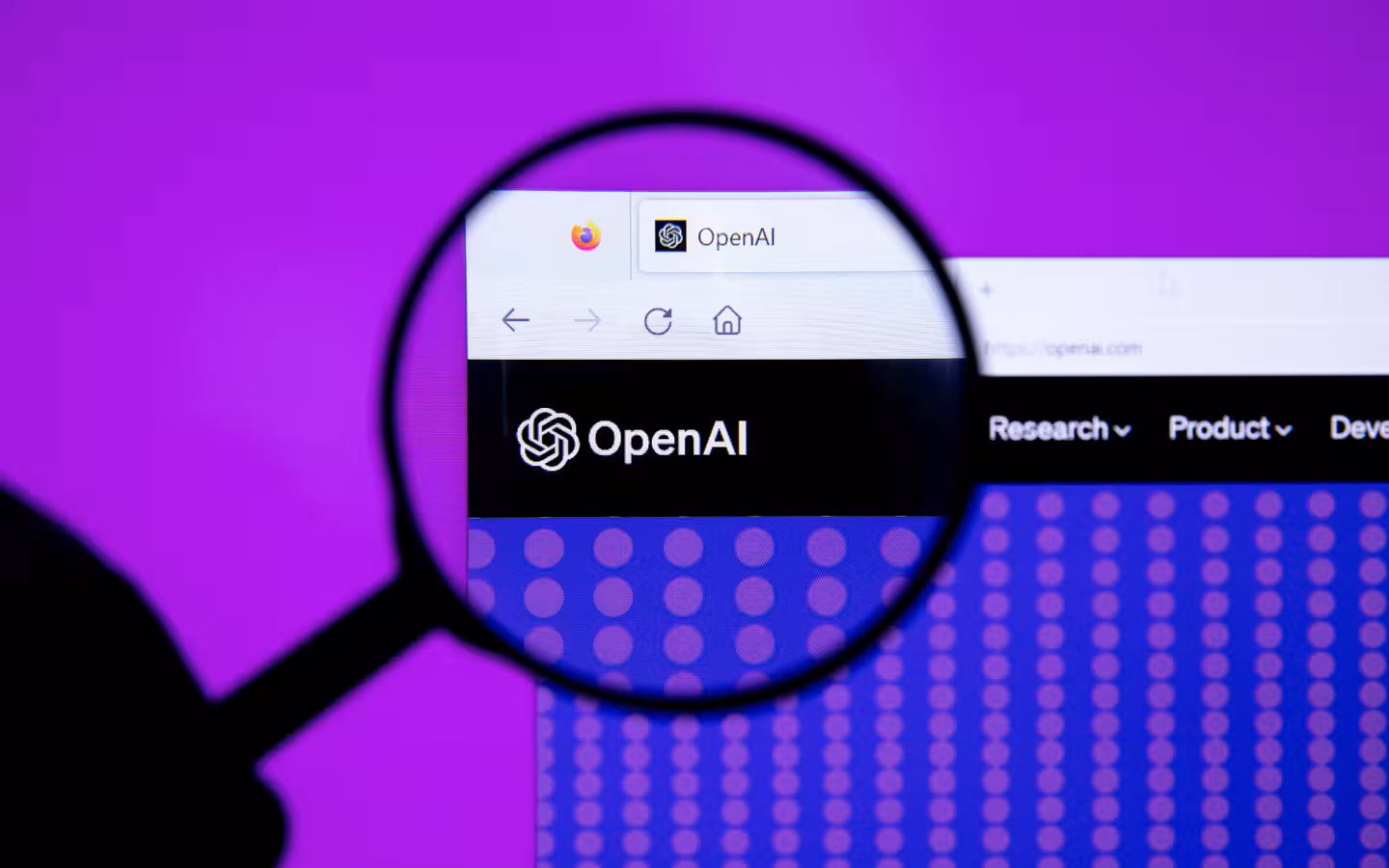 A magnifying glass enlarges the OpenAI logo on a browser screen.