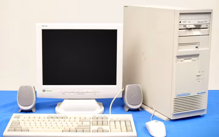 A Micron Millenia desktop tower beside a Gateway monitor, keyboard and speakers.