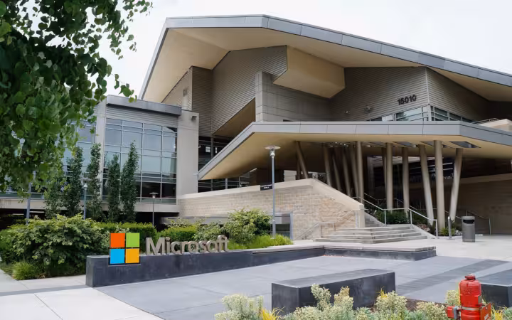 Building 92 of Microsoft Redmond Campus, with a Microsoft sign and landscaped entrance.