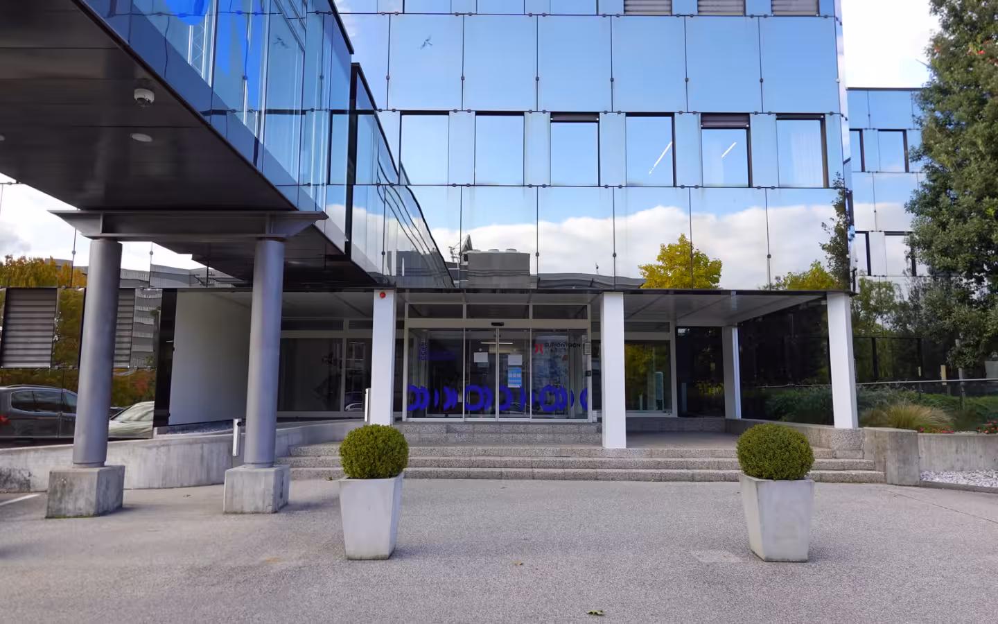 The glass-fronted European Broadcasting Union building and entrance in Le Grand-Saconnex.