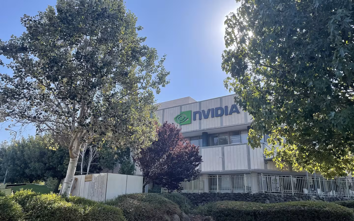 Nvidia's Tel Hai office building and logo framed by trees