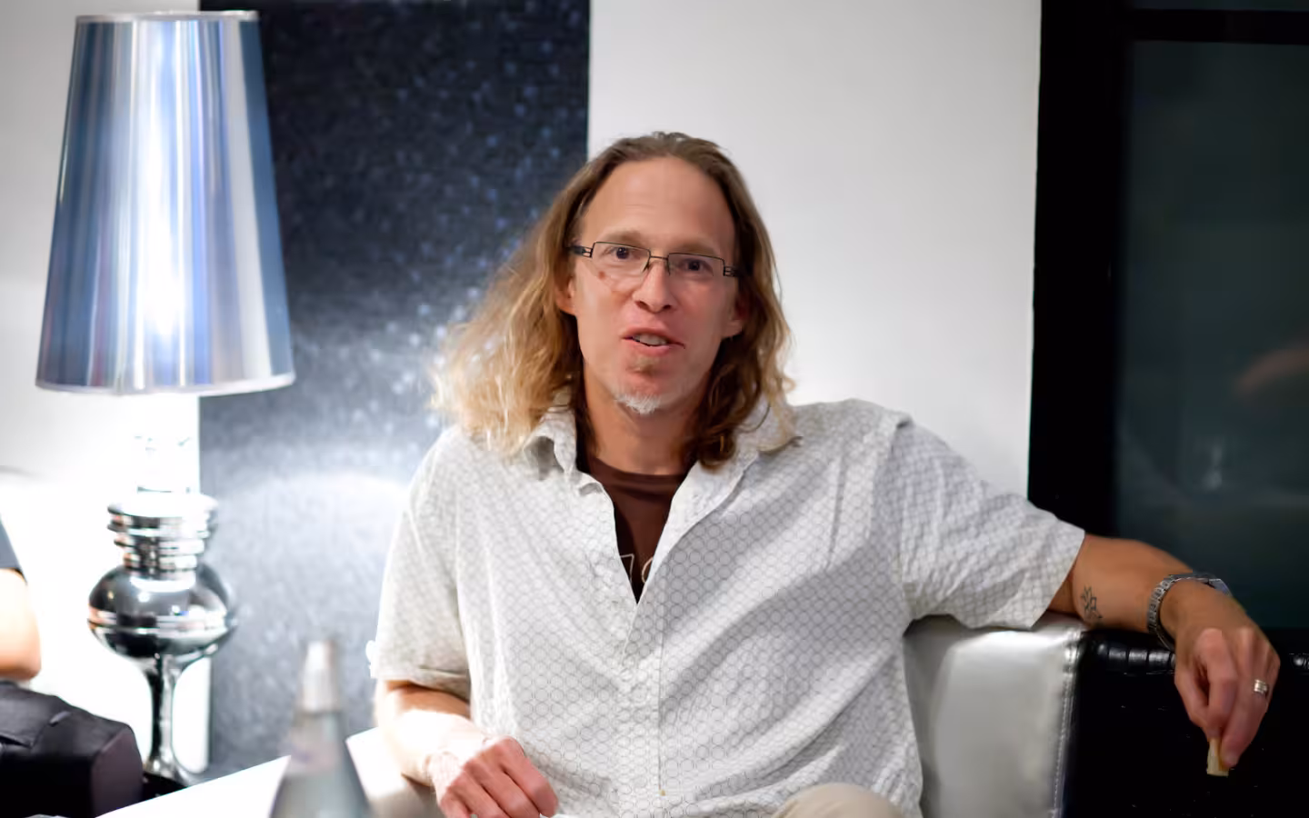 Mark Levine seated beside a large silver lamp in an office