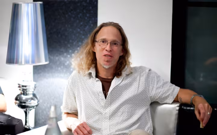 Mark Levine seated beside a large silver lamp in an office