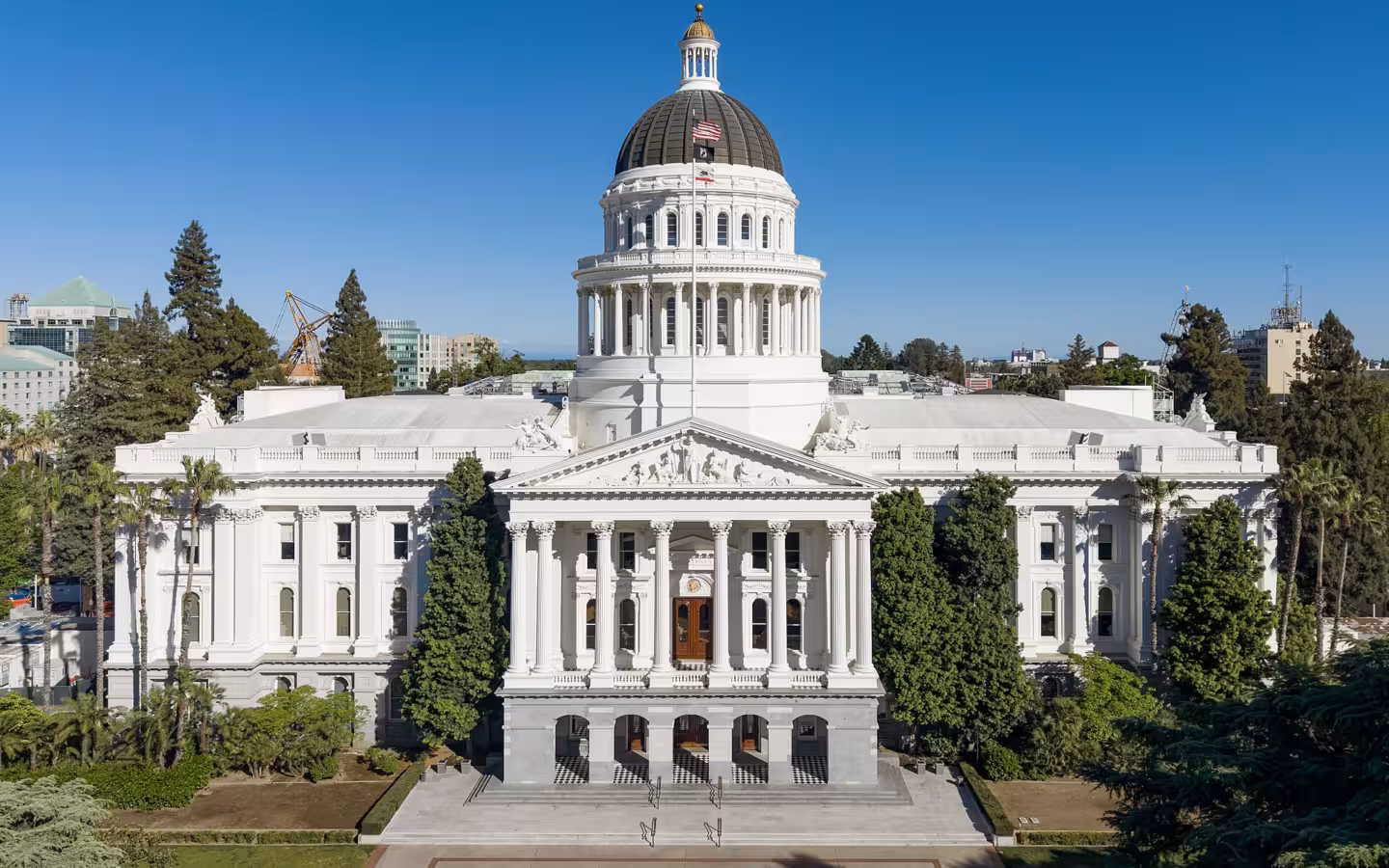 California State Capitol building in Sacramento beneath a clear blue sky