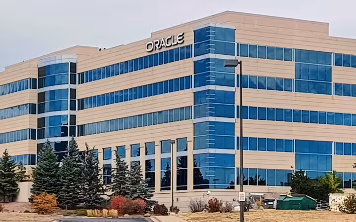 Oracle-branded office building in Colorado Springs, with blue windows and trees