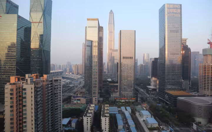 High-rise buildings and streets in Shenzhen, China, under a pale sky