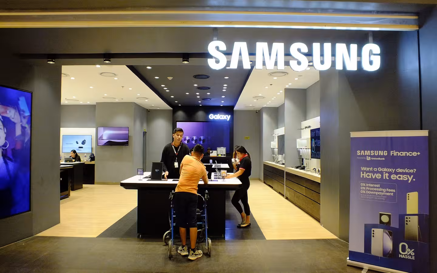 Samsung flagship store in Cebu City, with customers beneath an illuminated sign