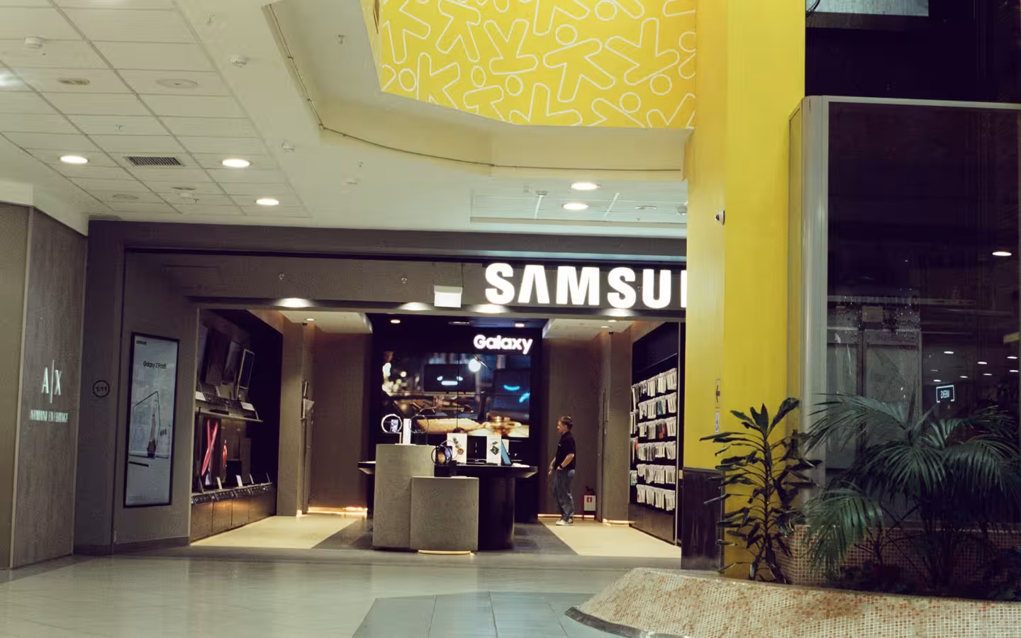Interior view of a Samsung Electronics store inside a shopping mall.