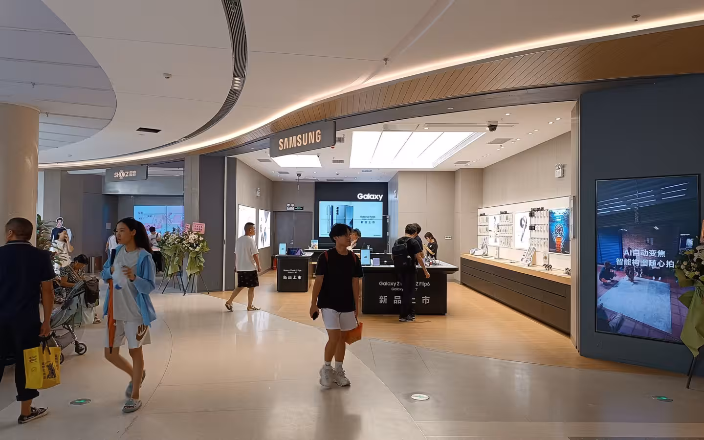 Samsung Store inside a Shenzhen mall, with shoppers passing its entrance
