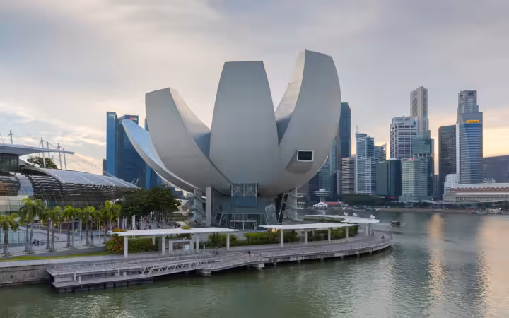 The ArtScience Museum at Marina Bay Sands in Singapore, with the city skyline behind it.
