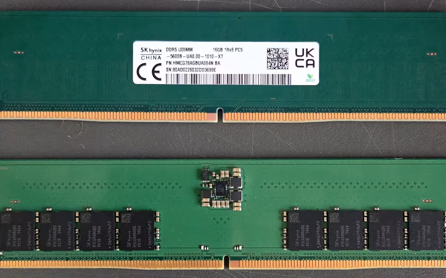 Two green SK hynix DDR5 memory modules photographed front and back.
