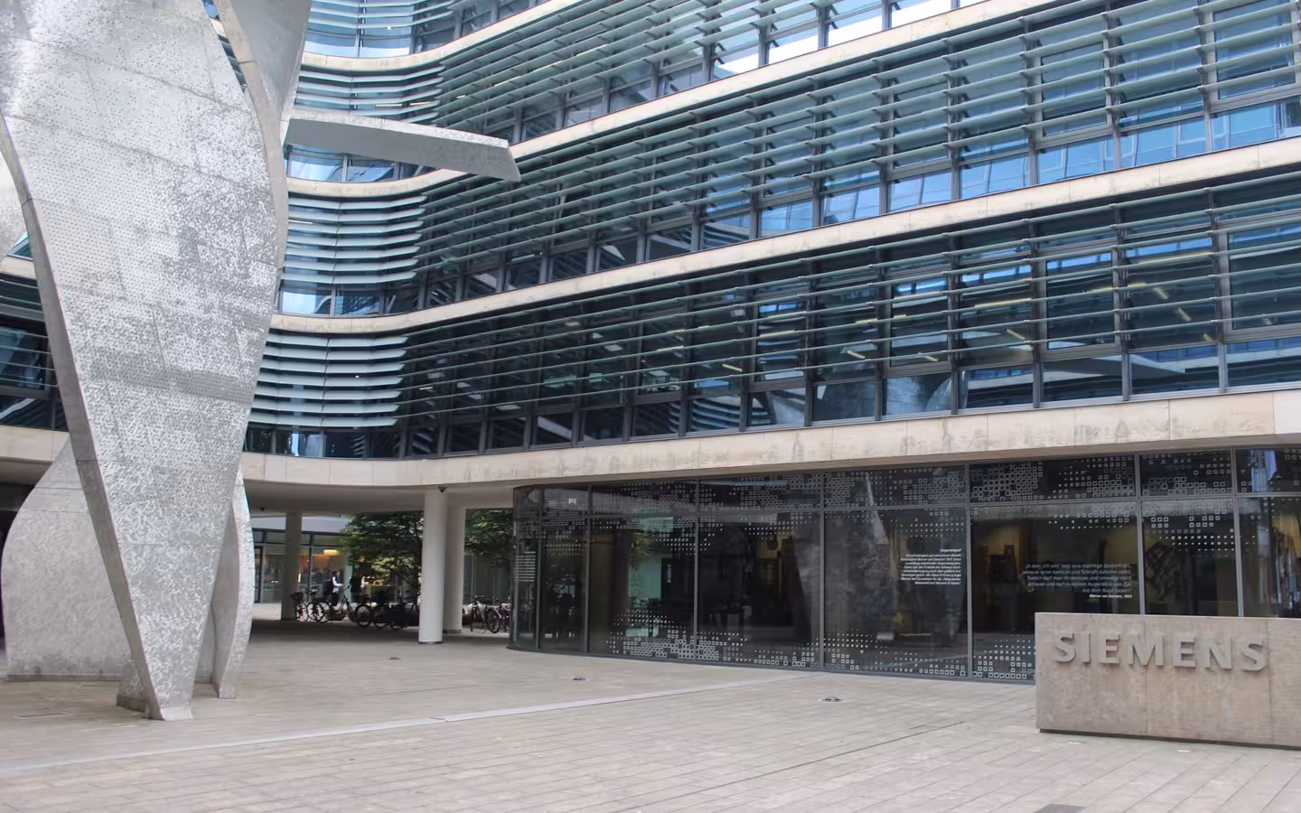 Siemens AG corporate headquarters in Munich, with a glass facade and Siemens sign